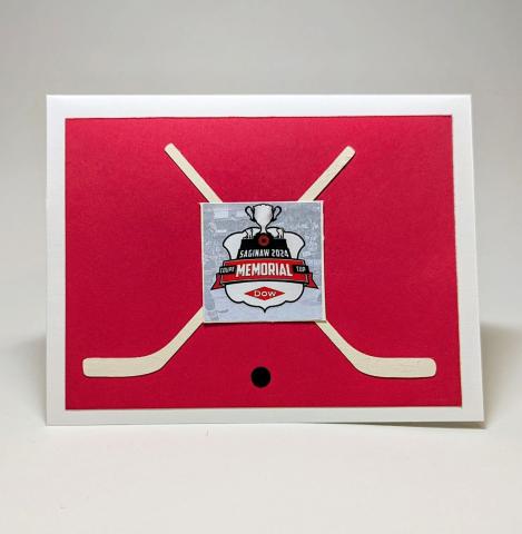 Memorial Cup Greeting card with hockey sticks, a puck and the logo.