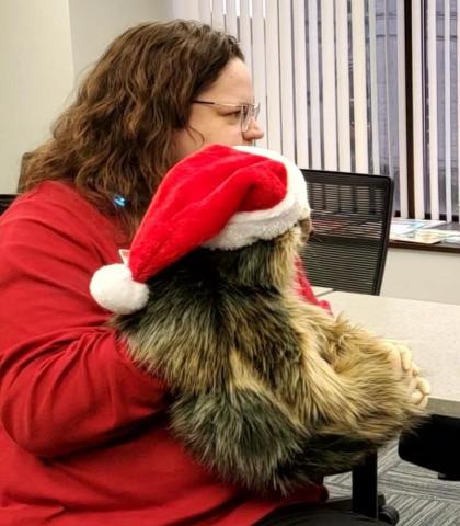 Miss Beth holds Carrot the Sloth puppet