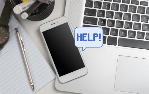 Phone and laptop with a text bubble saying "Help!"