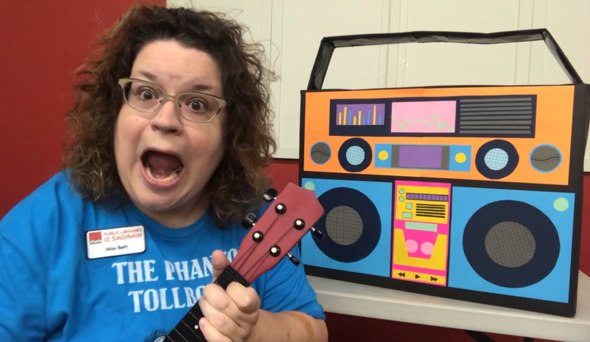 Miss Beth sings with her ukulele in front of her Boombox!